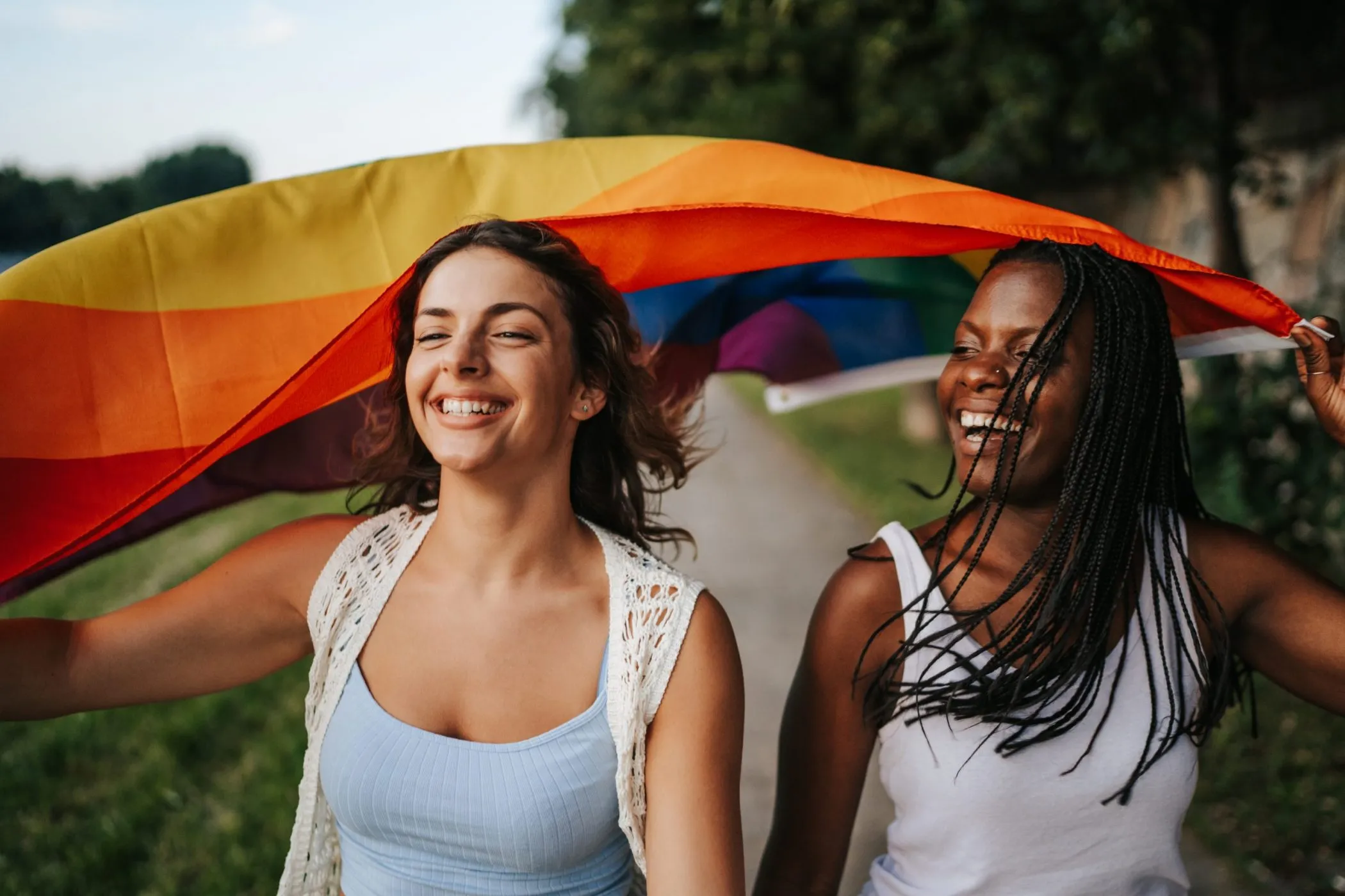 Women running with pride rainbow flag